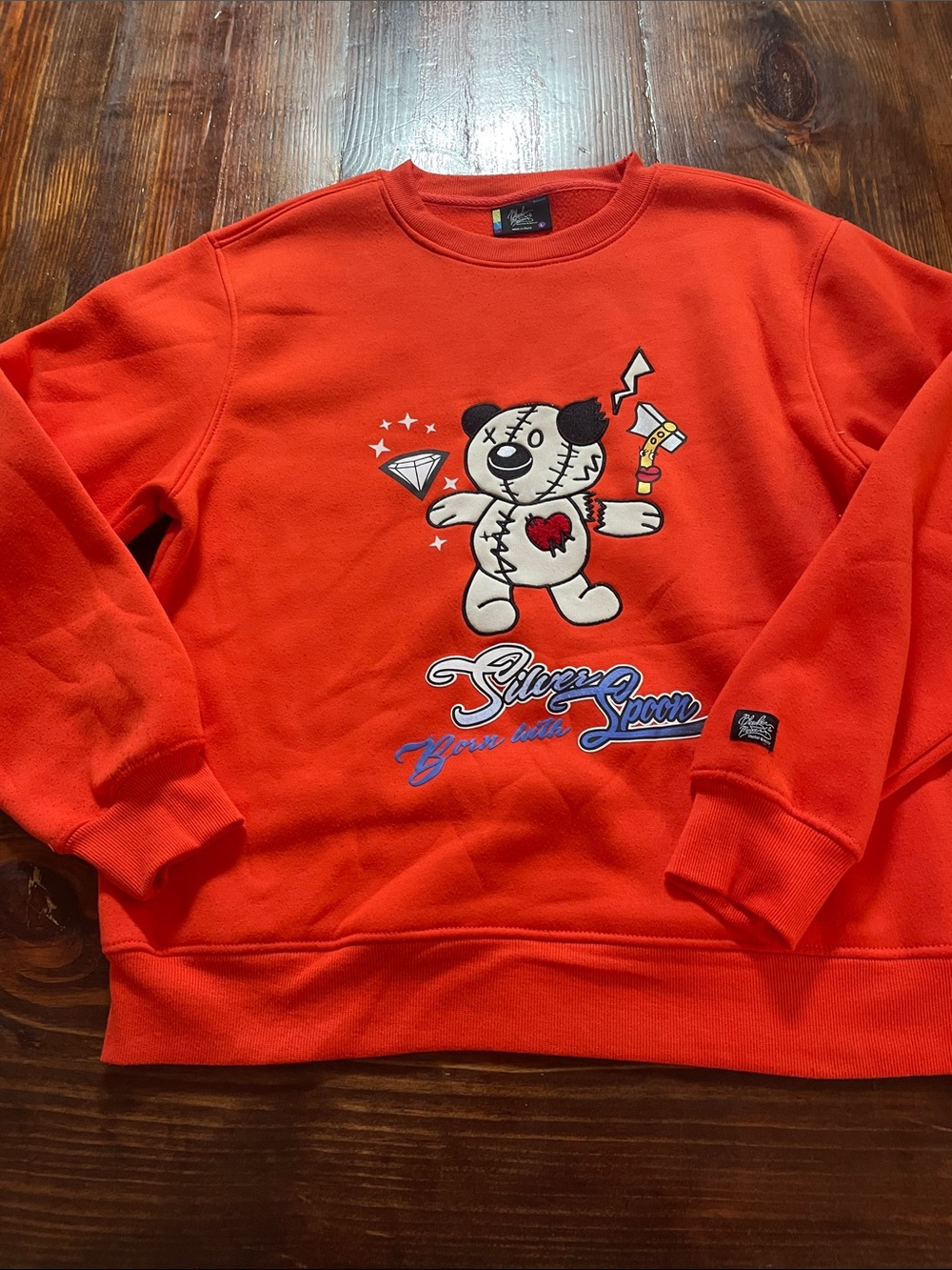 Orange Crewneck Sweatshirt with Teddy Graphic